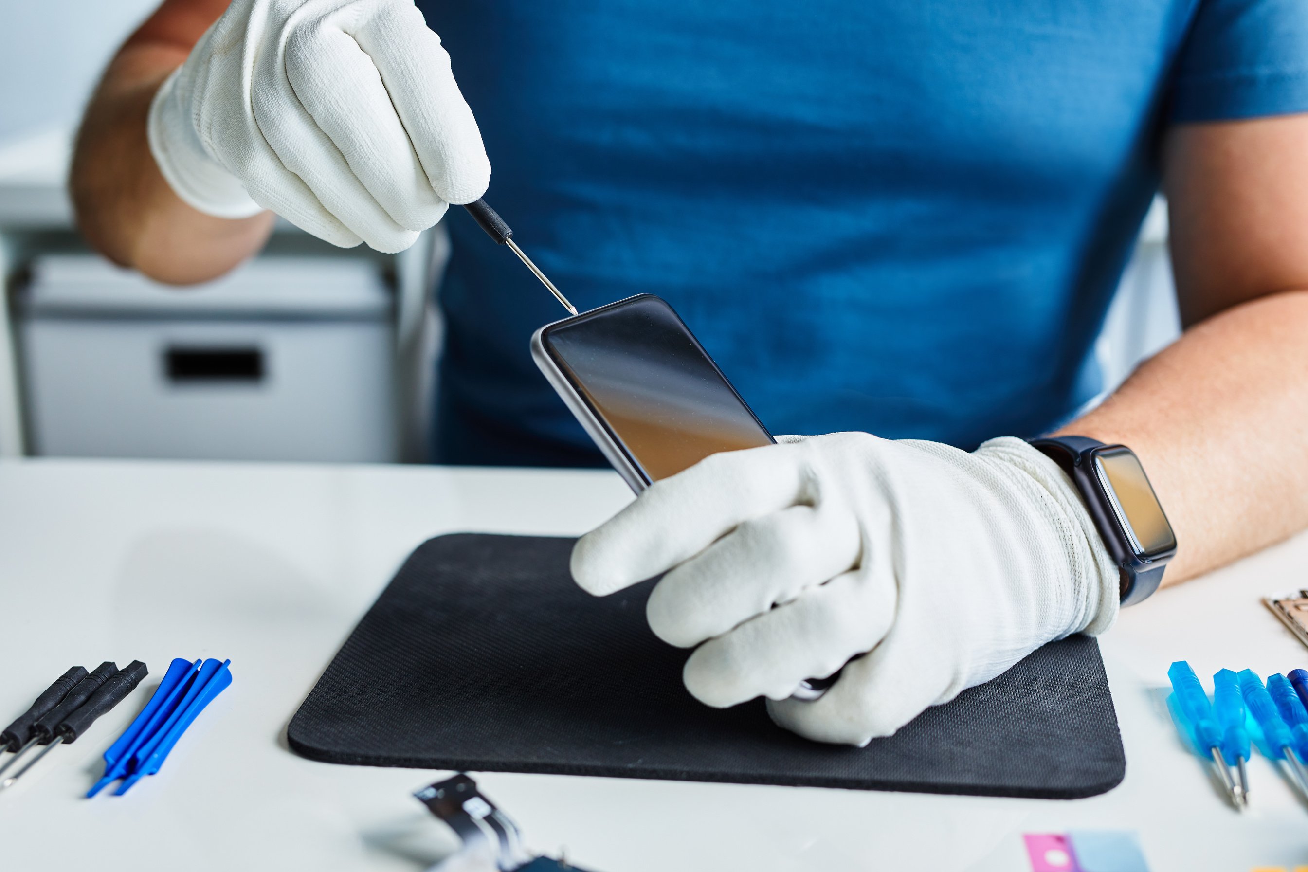 A Man Repairs a Broken Mobile Phone